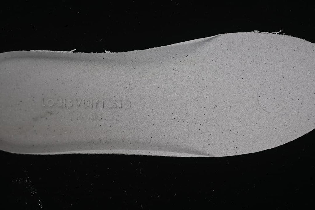 Close-up of the shoe insole with an embossed brand mark