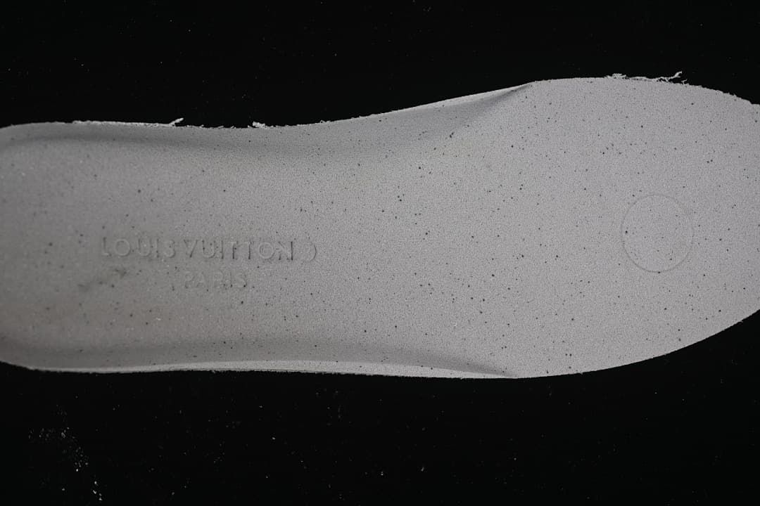 Close-up of the shoe insole with an embossed brand mark