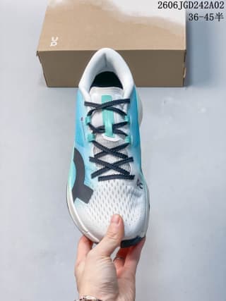 Top-down view showing the white toe box, turquoise side panels and black lacing.