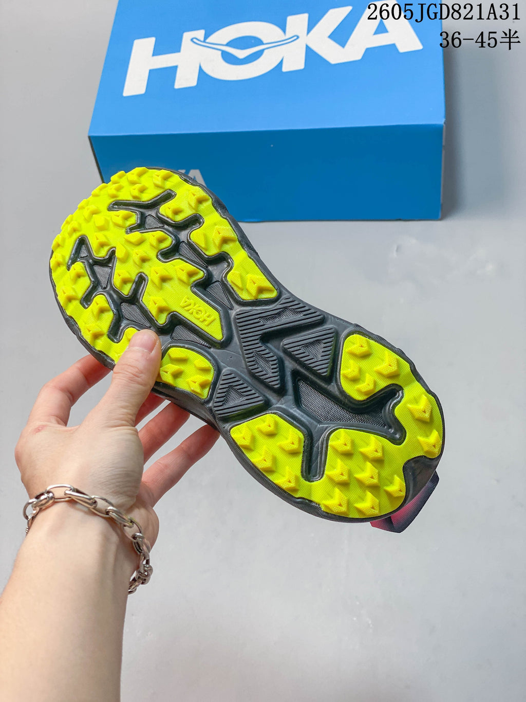 Close-up of the lugged outsole with yellow tread sections and dark detailing.