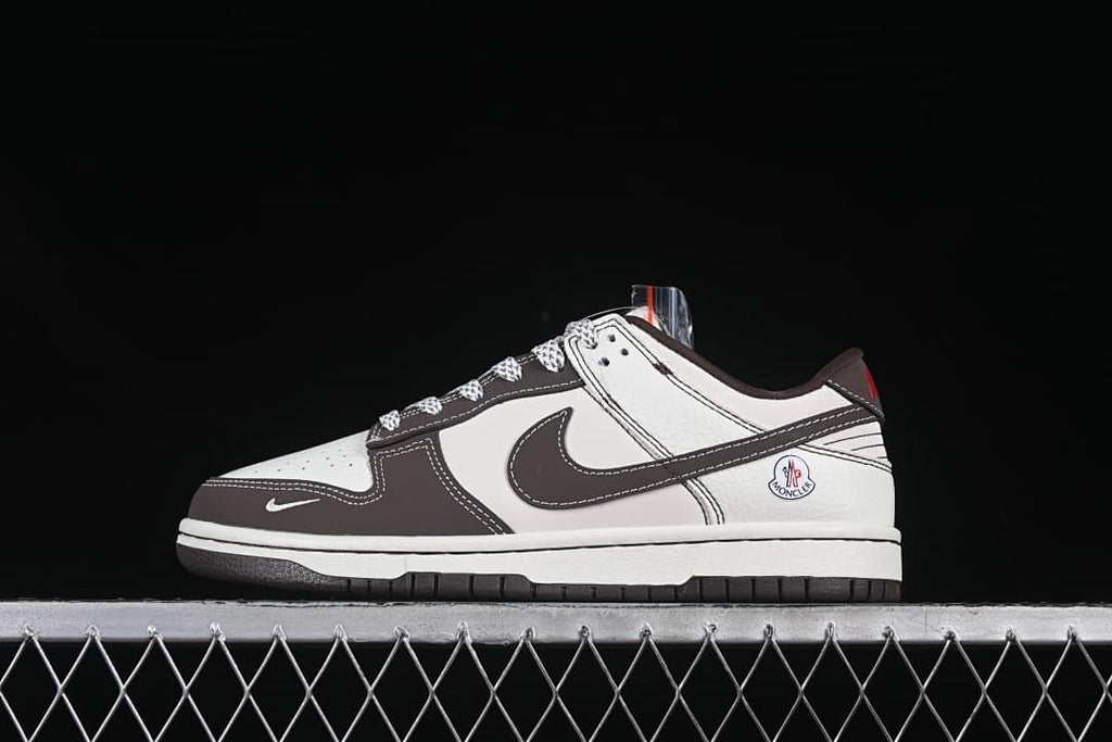 Side view of a cream and brown Nike SB Dunk Low sneaker with collaboration-style heel branding