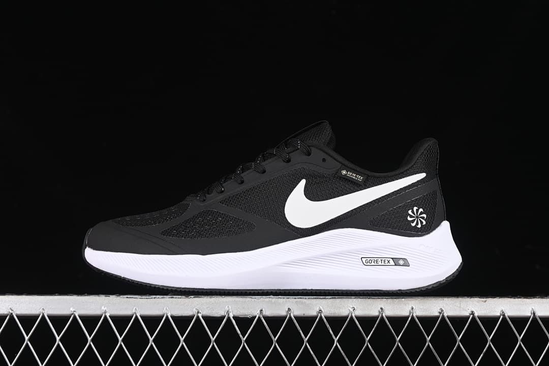 Side view of the black and white shoe against a dark background