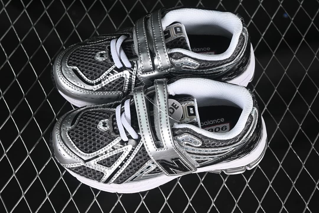 Pair of silver and black kids sneakers shown from above