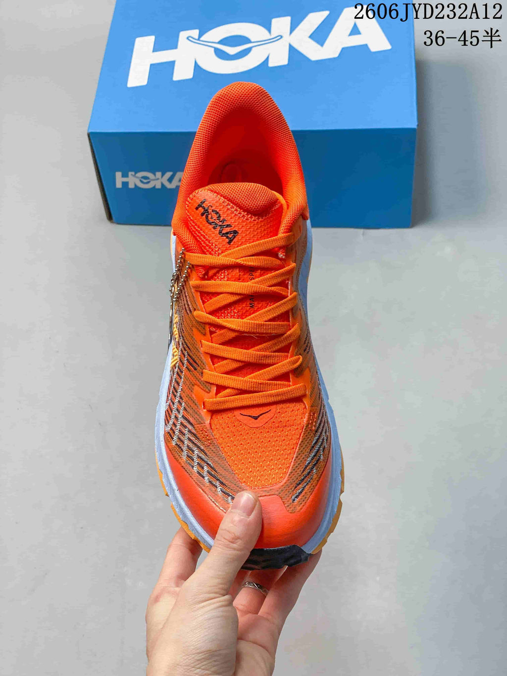 Top-down view of the orange shoe showing its laces and patterned upper