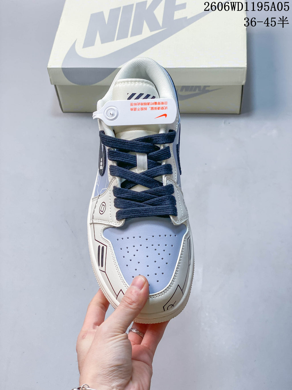 Top view showing the perforated pale blue toe, navy laces, and graphic trim
