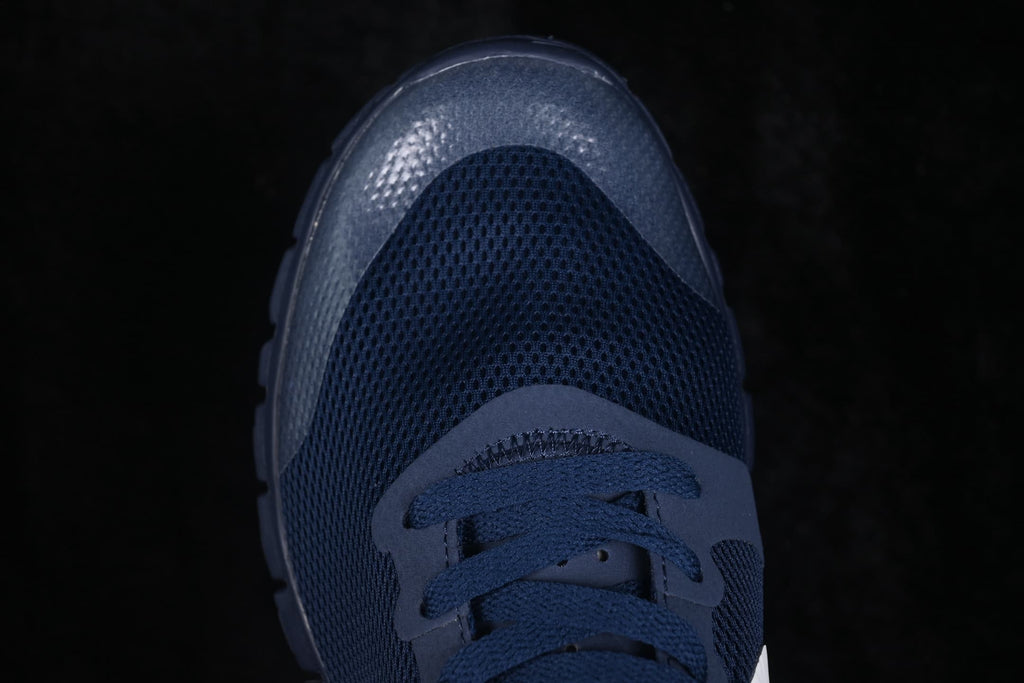 Close-up of the navy perforated forefoot, laces, and textured toe overlay.