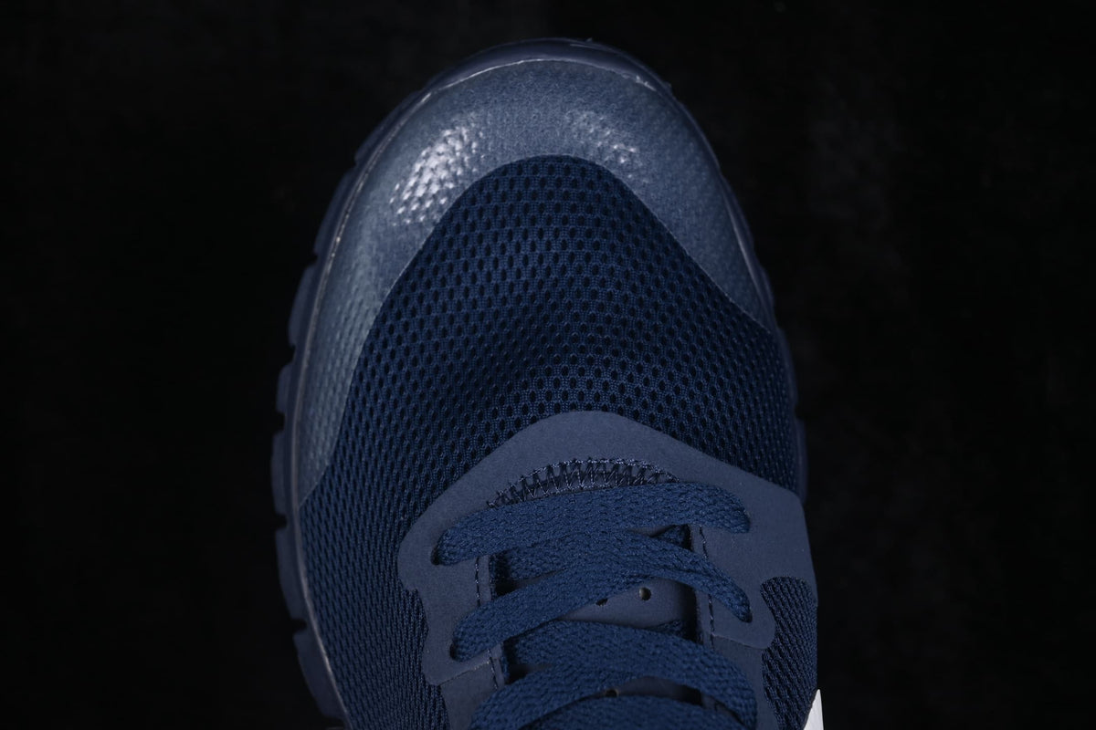 Close-up of the navy perforated forefoot, laces, and textured toe overlay.
