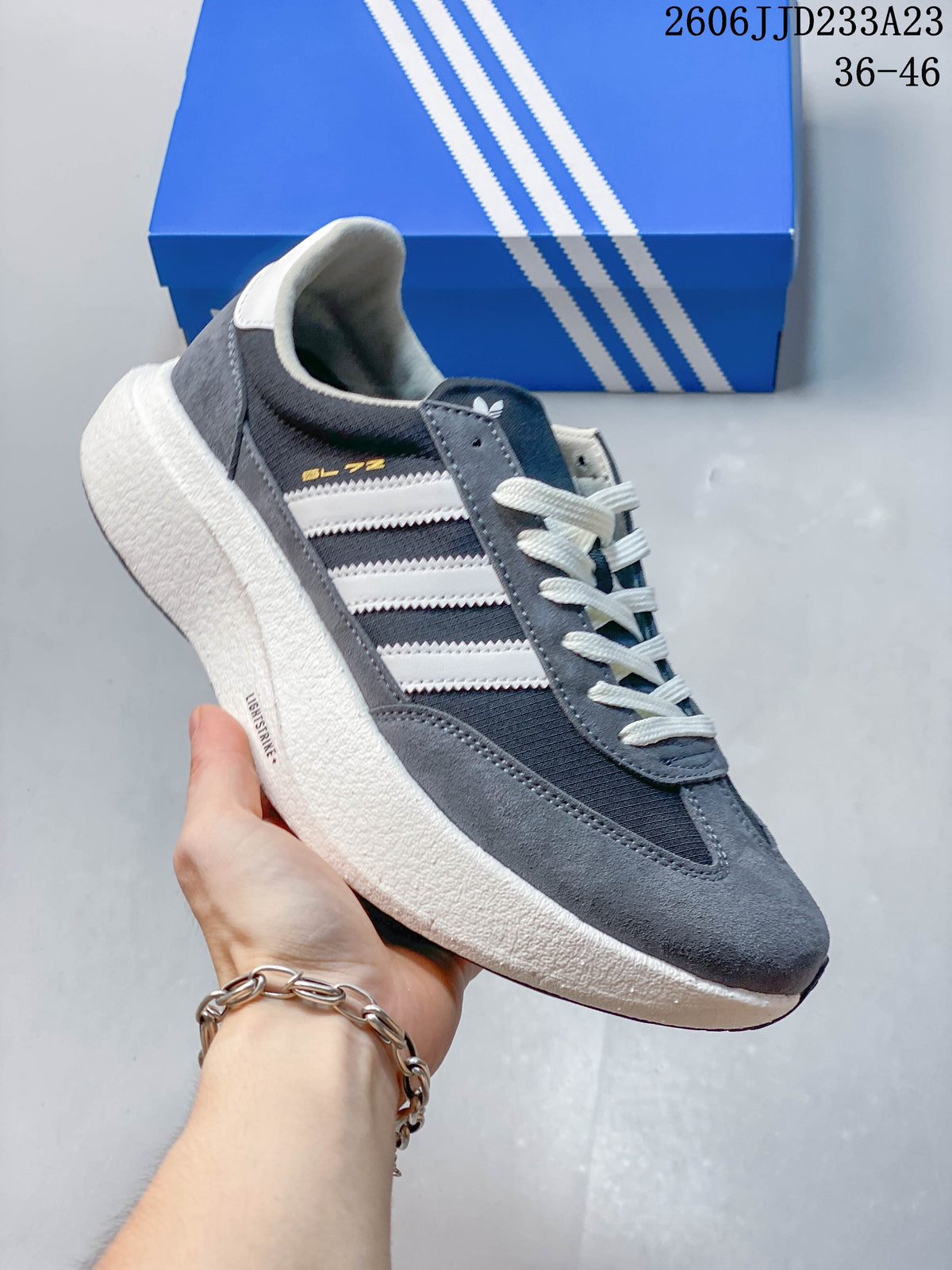 Side view of the gray and white adidas Originals SL 72 Pro sneaker