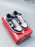 Pair of black and pale pink Nike Dunk low-top sneakers displayed on a red shoebox