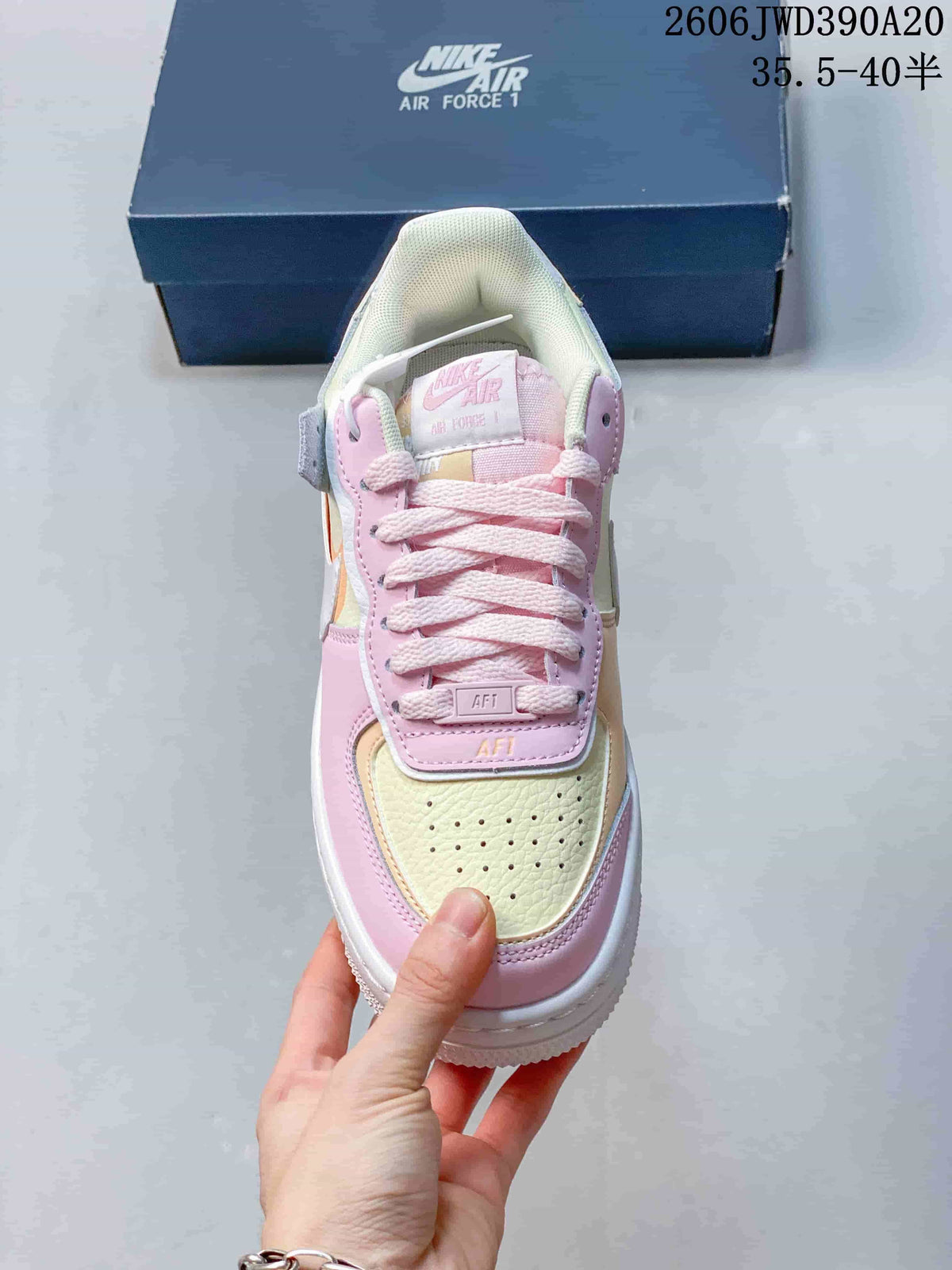 Top view of a pastel Nike Air Force 1 sneaker showing the laces and perforated toe.
