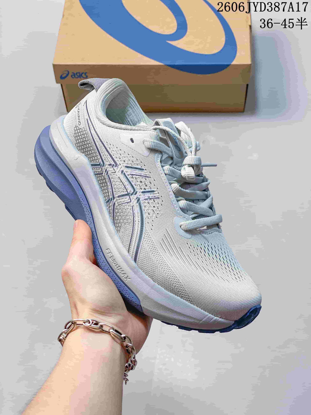 Angled side view of the white and blue ASICS Gel-Kayano 33 running shoe