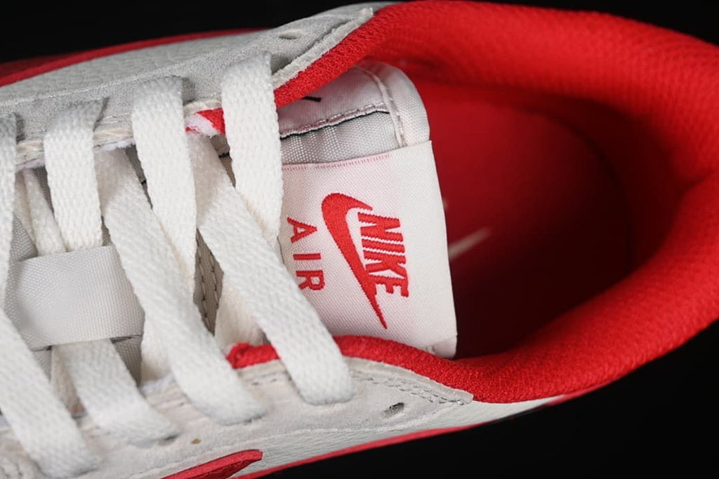 Close-up of the tongue label, white laces, and red collar lining.