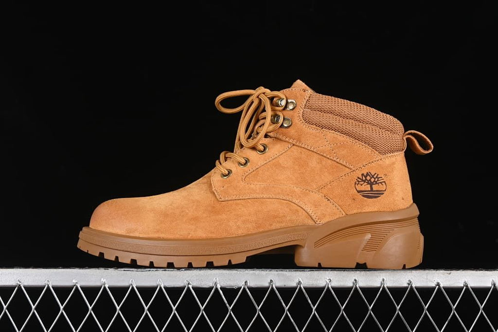 Side view of a yellow-brown Timberland TB10088 mid-top lace-up boot