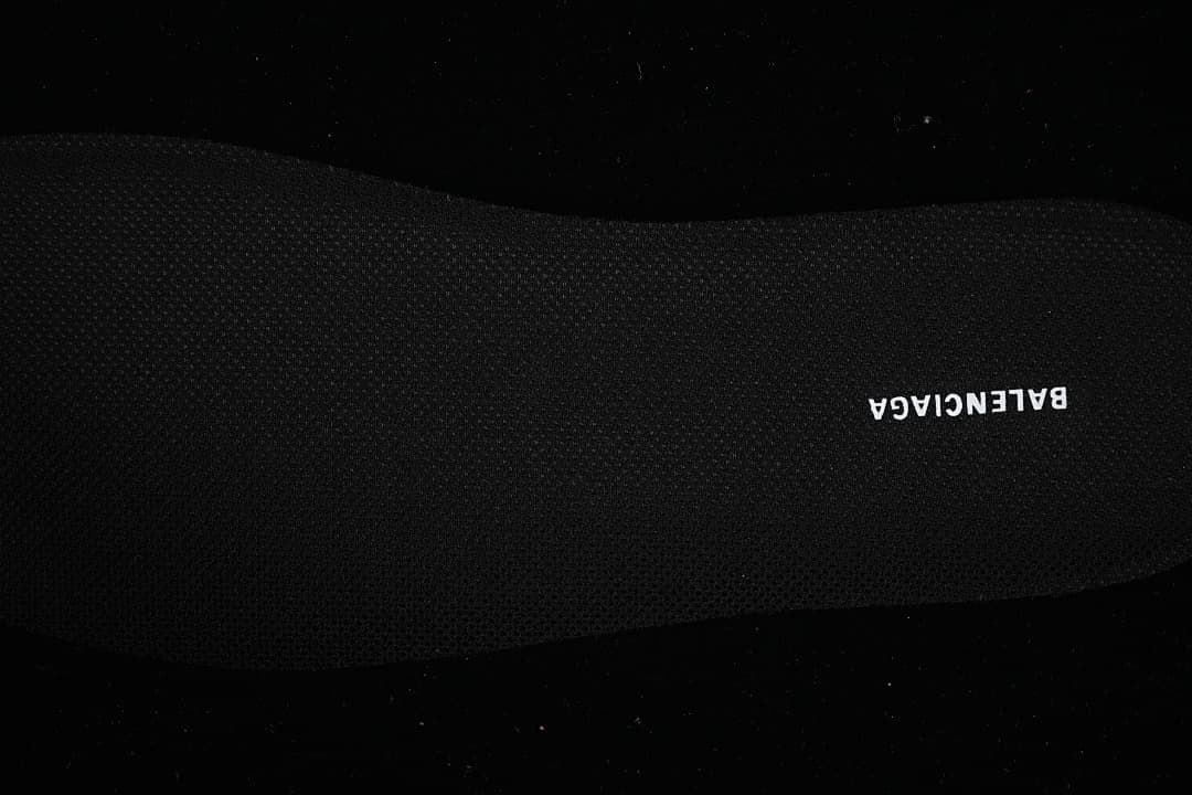 Close-up of the black insole with branding.