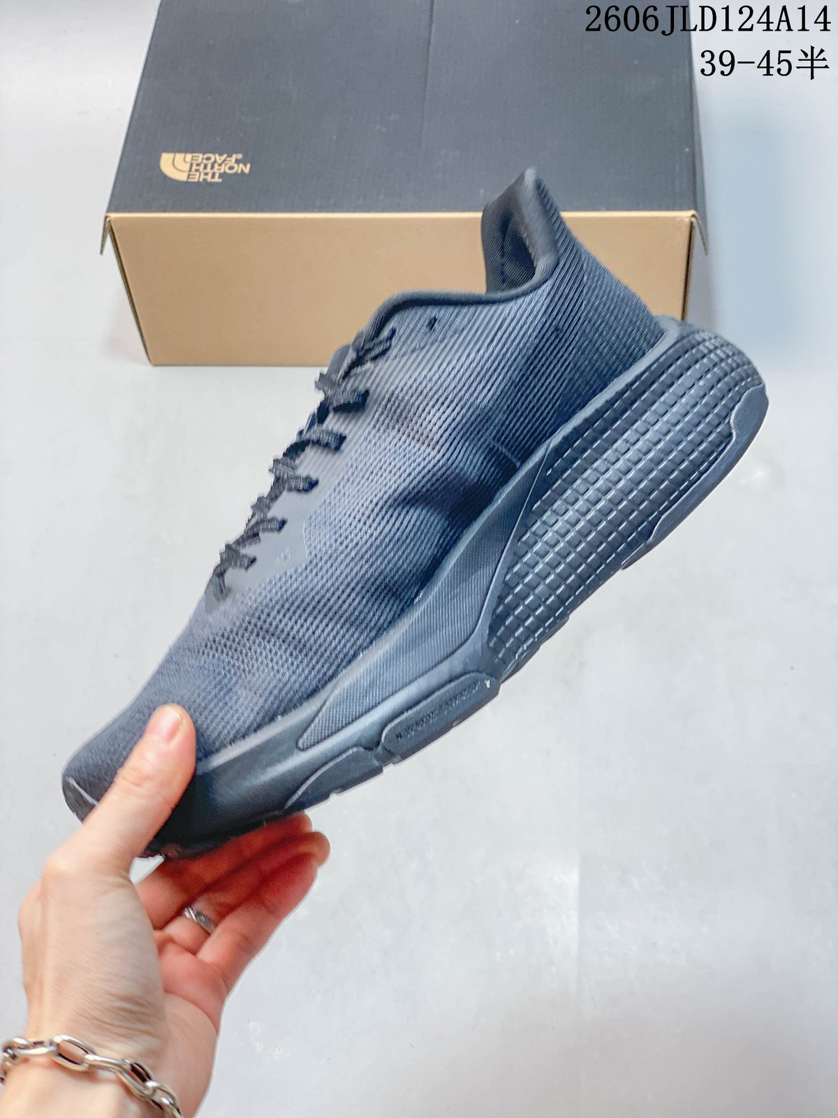 Side profile of a gray lace-up trail running shoe.