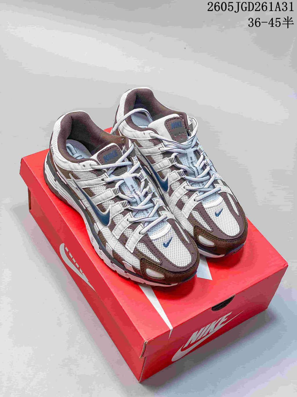Pair of white Nike P-6000 sneakers with brown and blue-gray accents.