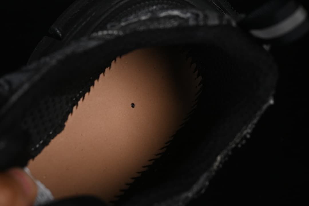 Close-up of the black sneaker's inner opening and lining.