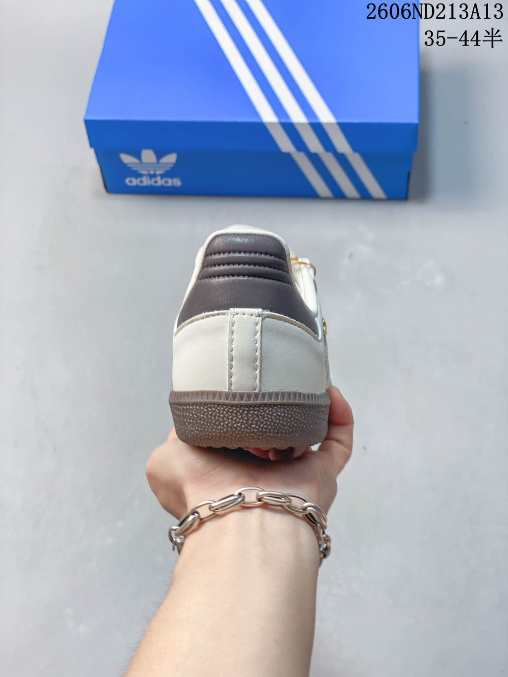 Rear view of a white adidas Samba OG sneaker with grey heel detailing