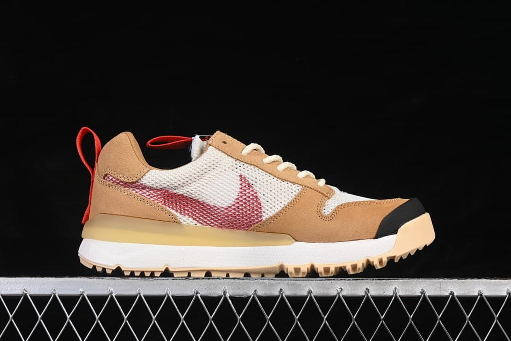 Side profile showing the red Swoosh, mesh panels, tan overlays, and rugged outsole
