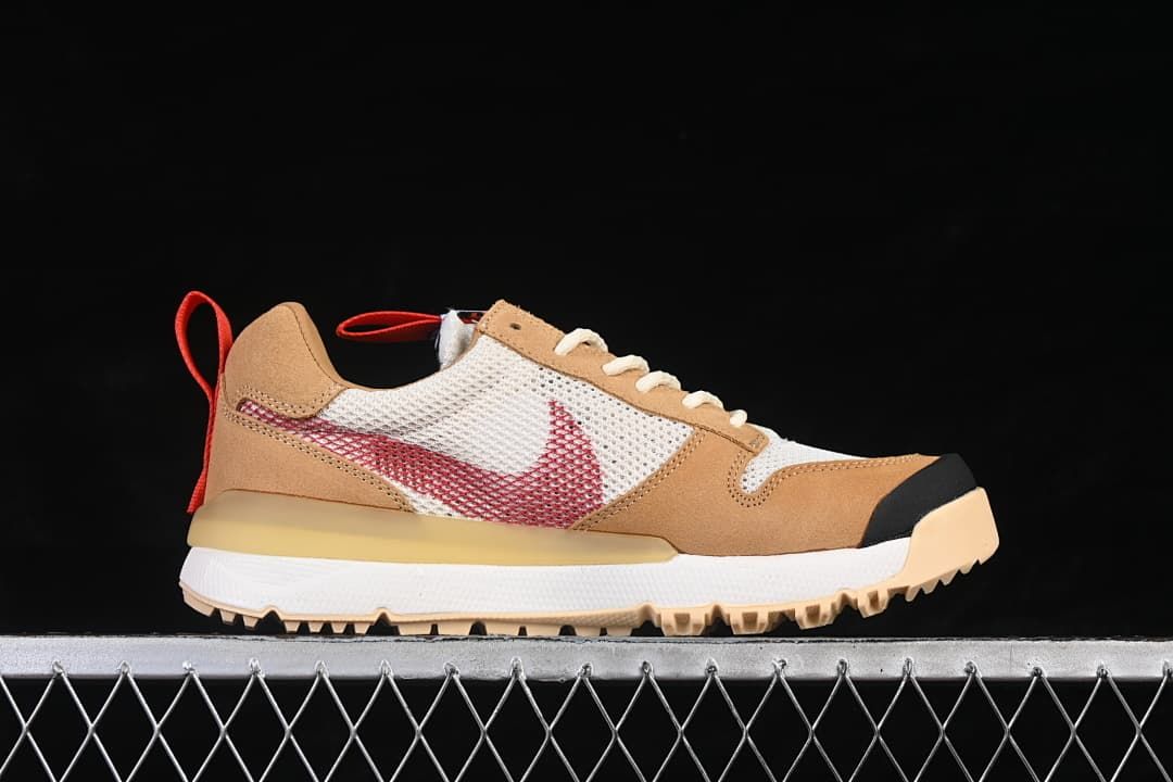 Side profile showing the red Swoosh, mesh panels, tan overlays, and rugged outsole