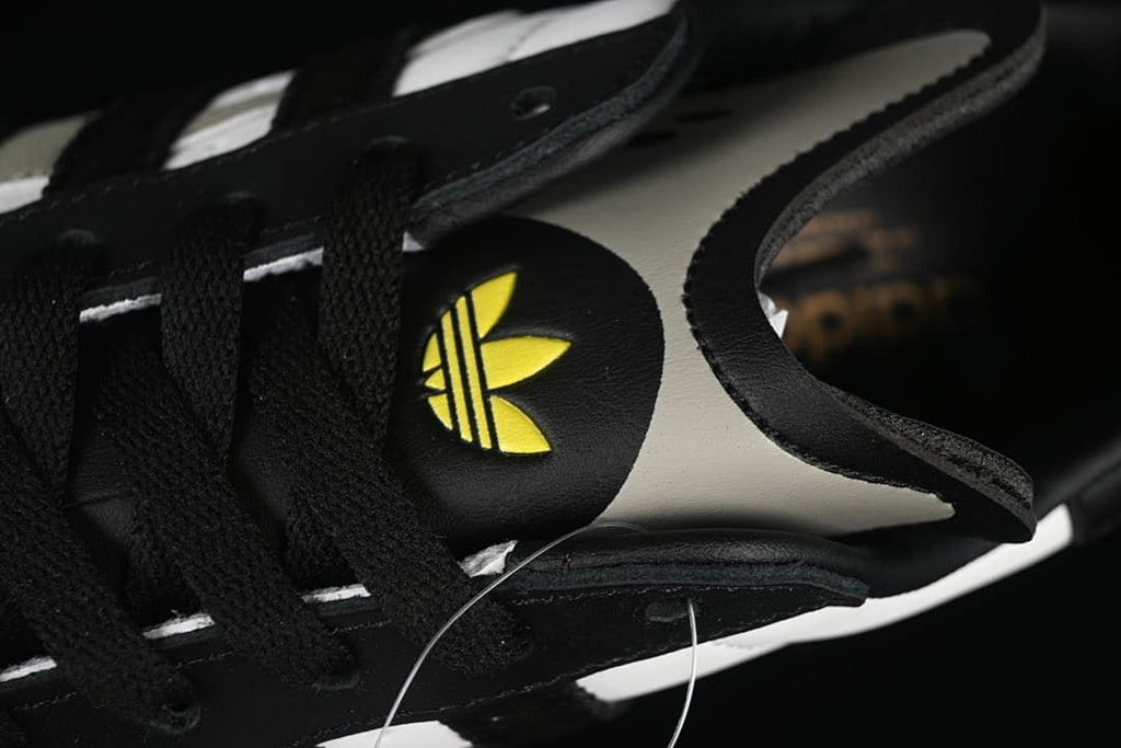 Close-up of the tongue, laces, and yellow Trefoil detail