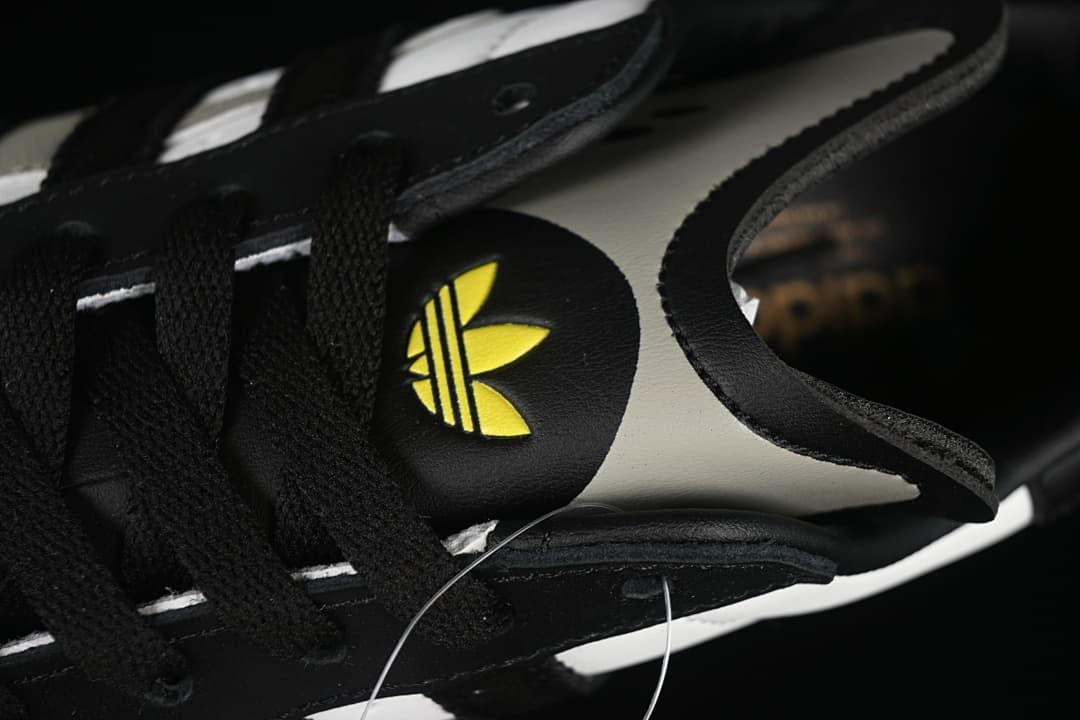 Close-up of the tongue, laces, and yellow Trefoil detail
