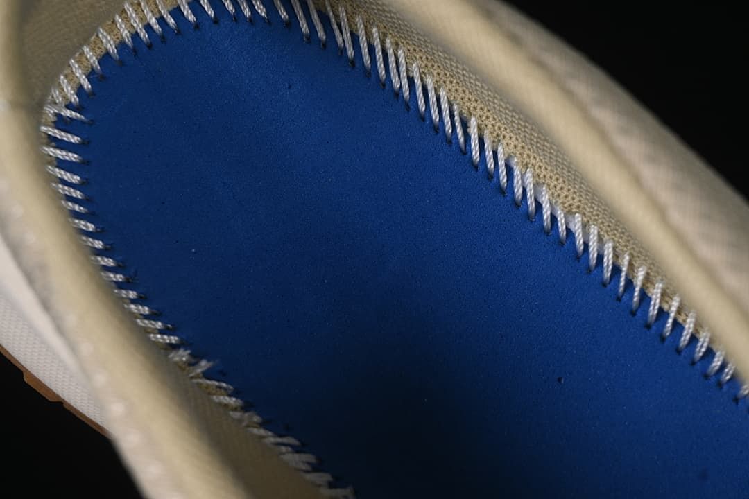 Close-up view inside the shoe showing a blue footbed section and stitched edge.