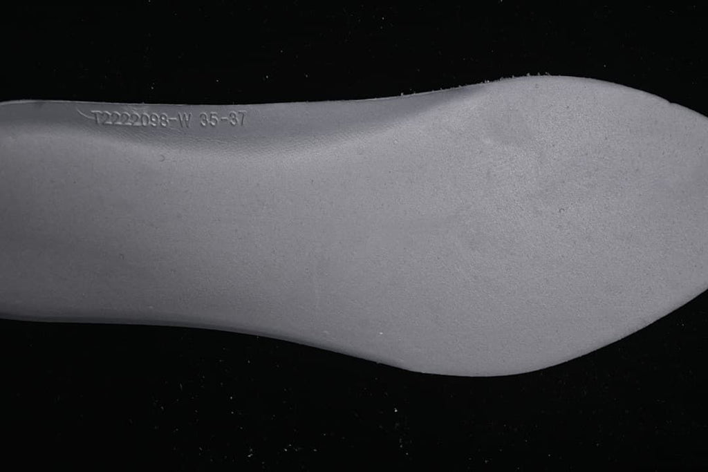 Close-up of a shoe sole with embossed size range text.