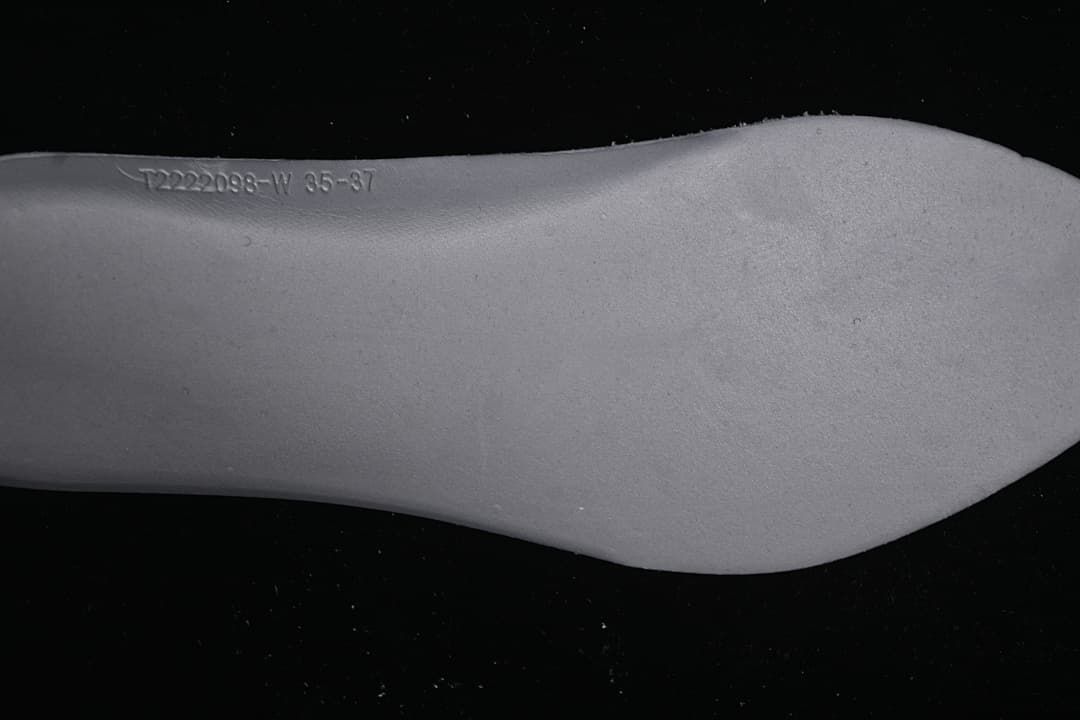Close-up of a shoe sole with embossed size range text.