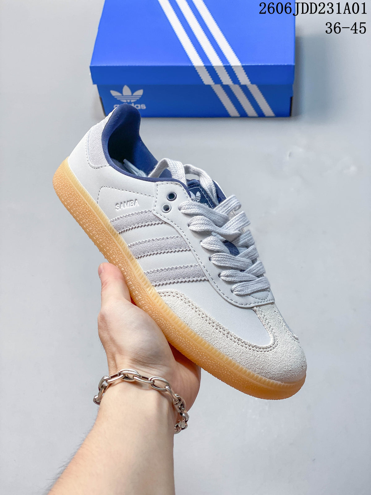 Side view showing the Samba name, gray stripes, textured toe panel, and gum-colored sole.