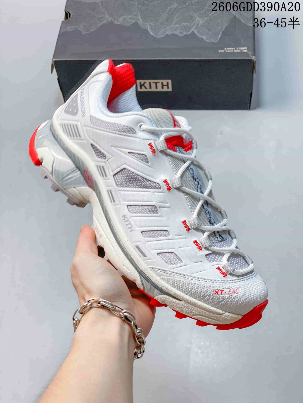 Side view of the shoe showing XT-4K lettering, gray panels, and red outsole accents