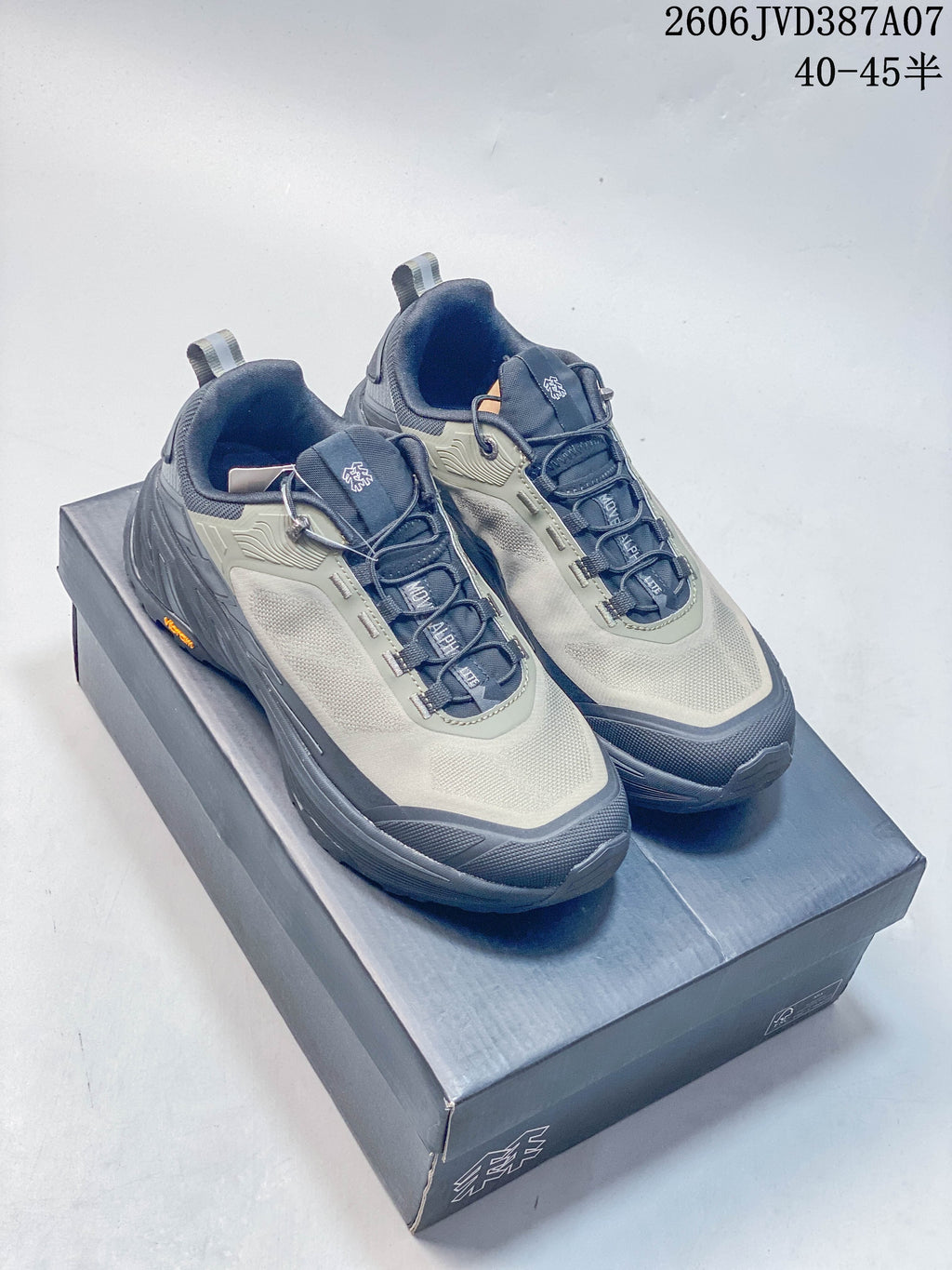 Pair of gray and navy Kolon Sport low-top sneakers on a shoebox