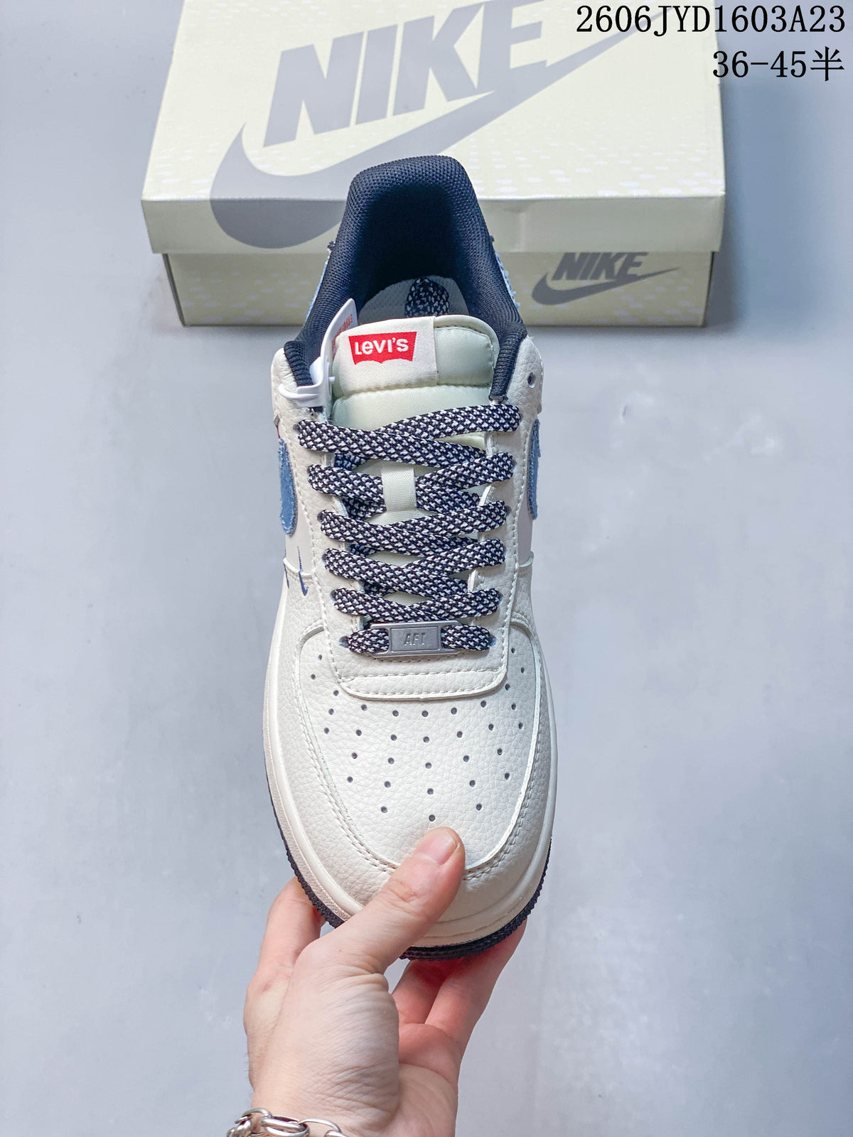 Front view showing the perforated toe, patterned laces, and red tongue label