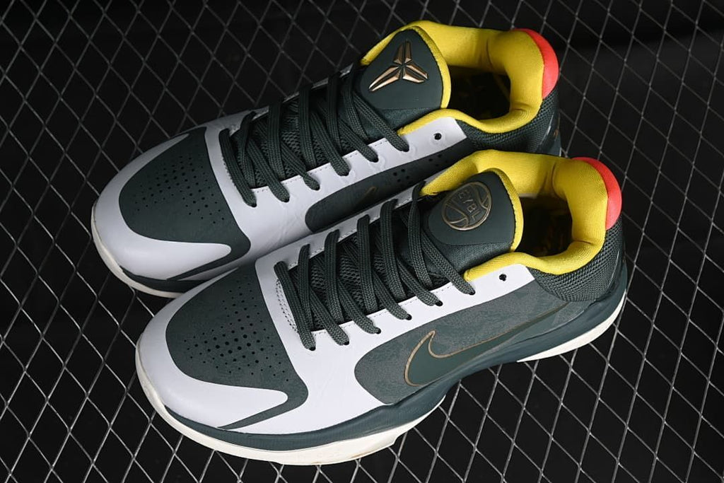 Pair of dark green and white Kobe basketball shoes shown from above