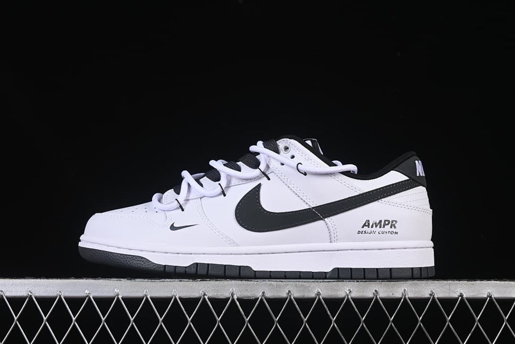 Side profile of the white and black sneaker with layered laces and heel graphic