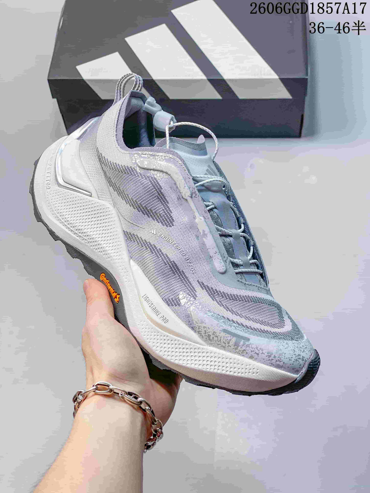 Side view highlighting the adidas Holo Peak shoe’s gray upper and chunky sole