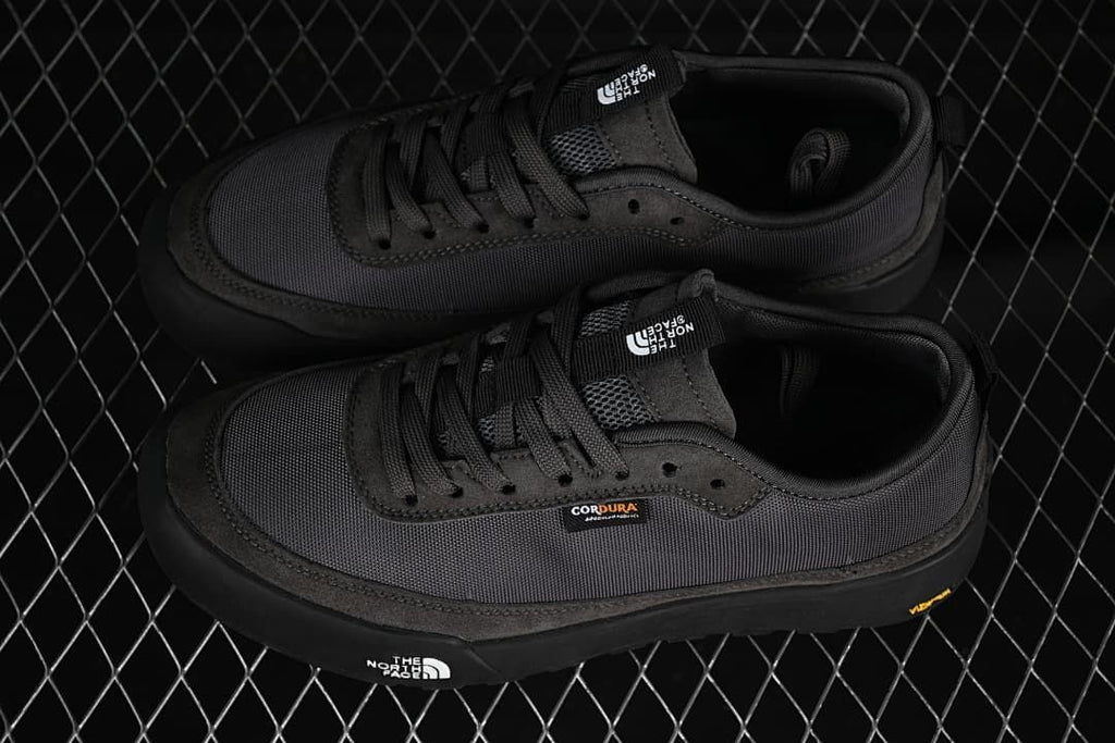 Pair of charcoal grey low-top sneakers viewed from above