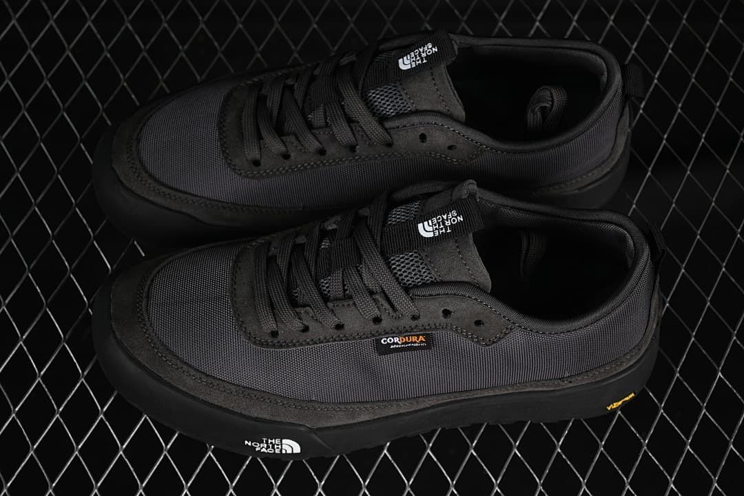 Pair of charcoal grey low-top sneakers viewed from above