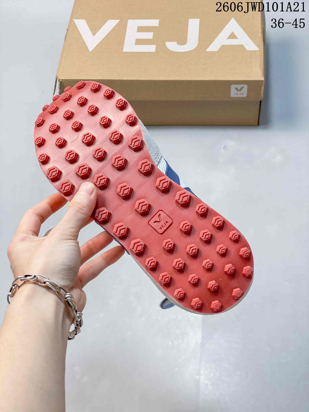 Red outsole with raised tread blocks on a Veja sneaker