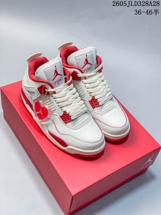 Pair of white and red Air Jordan 4 sneakers on a red shoe box