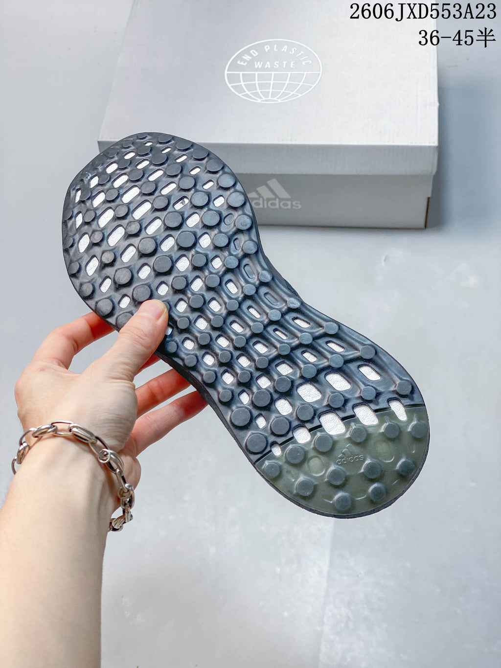 Close-up of the textured outsole on an Adidas PureBoost 21 shoe.