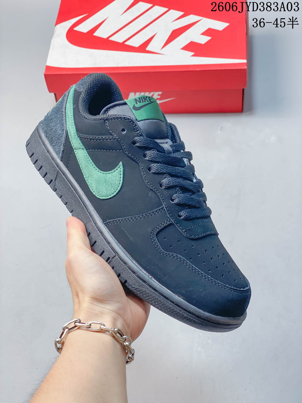 Angled close-up of the navy sneaker with mint-green Swoosh and tongue detail