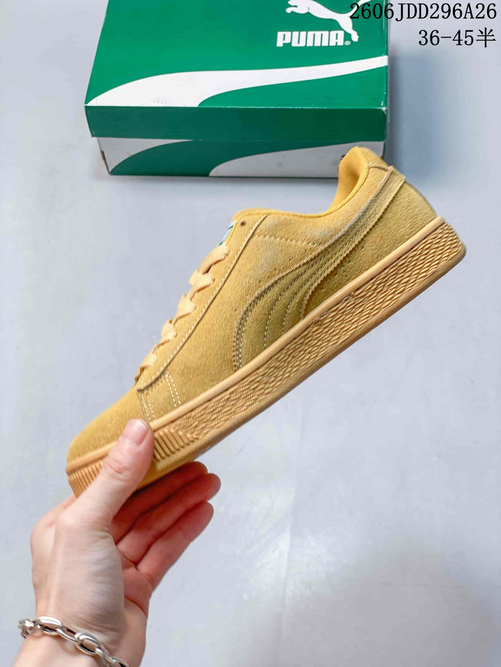 Side profile of the wheat-toned low-top sneaker with a contrasting side formstrip