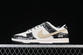 Side view of off-white and black Nike SB Dunk Low sneakers with snakeskin-pattern panels and a light tan Swoosh.