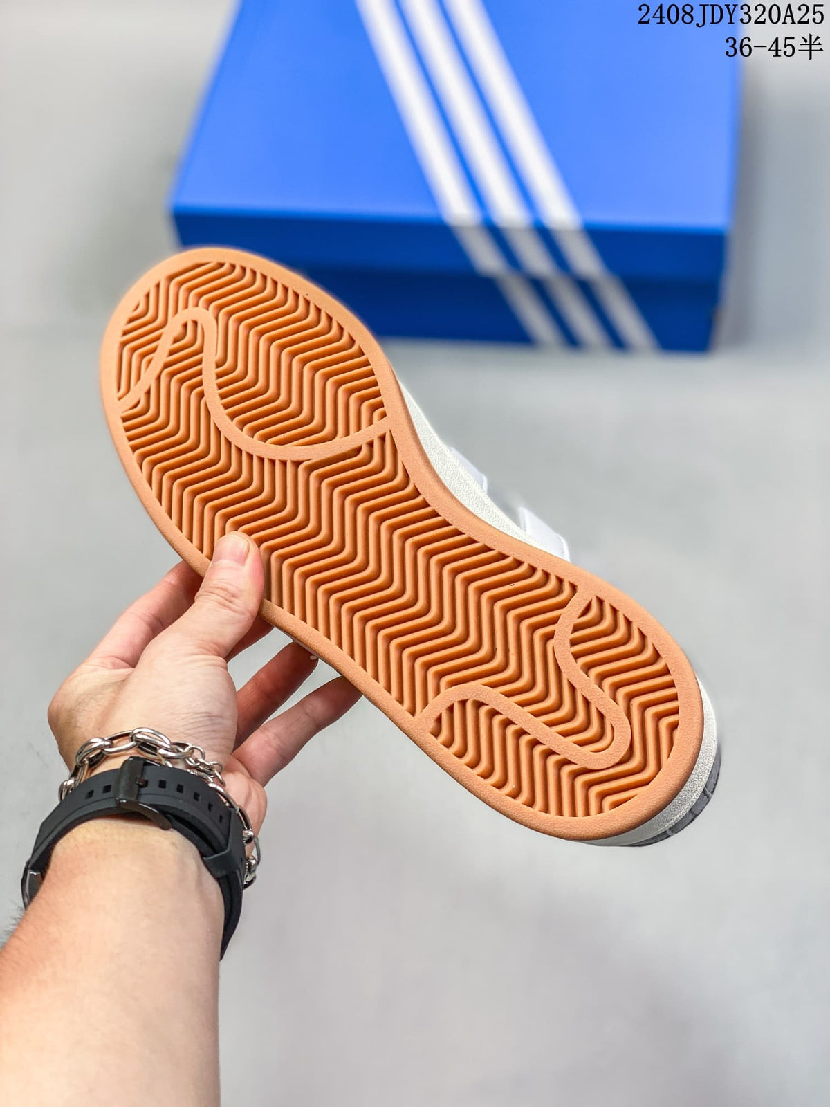 Underside of the sneaker showing a gum-colored outsole with a patterned tread.