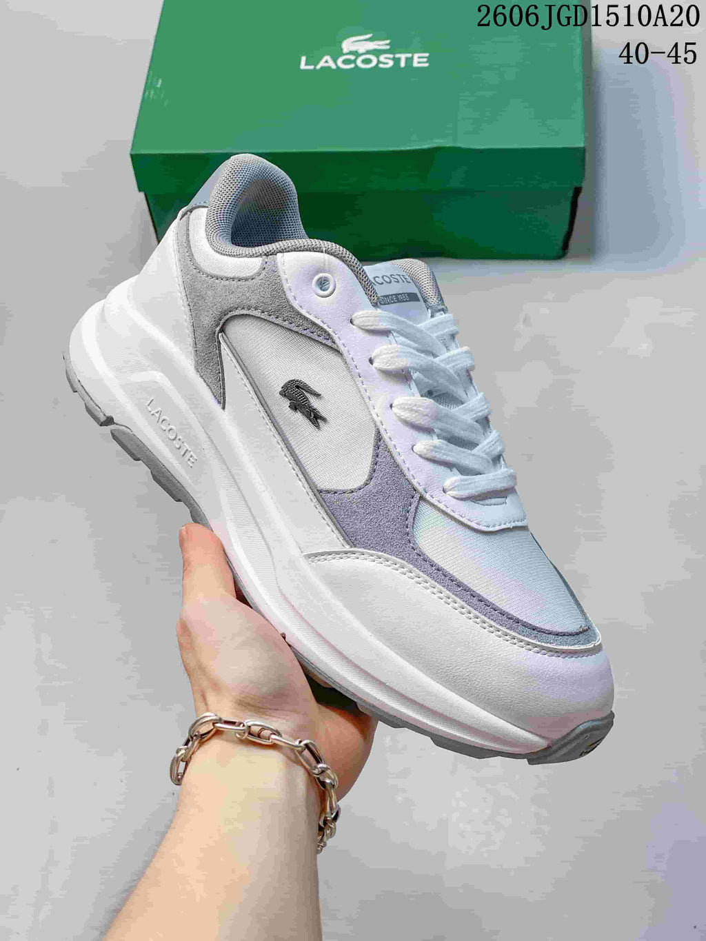White and light gray Lacoste low-top sneaker with a crocodile side emblem