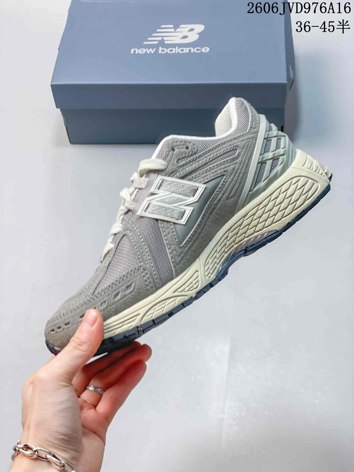 Side view of a grey New Balance sneaker with layered panels and a prominent N logo.