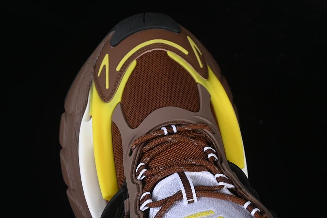 Top view of the brown mesh toe, laces, and yellow overlays