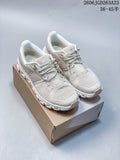 Pair of light ivory On Cloudtilt Remix sneakers displayed on a shoebox