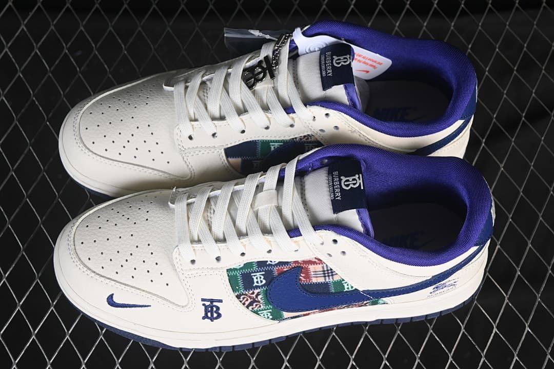 Overhead view of a pair of white and blue low-top sneakers showing the patterned side panels, laces, and tongue labels.